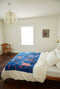 blue throw blanket with people on it