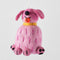 Pink dog-shaped ornament with a pre-order label on a light gray background