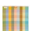 Colorful checkered towel with a brand label on a white background