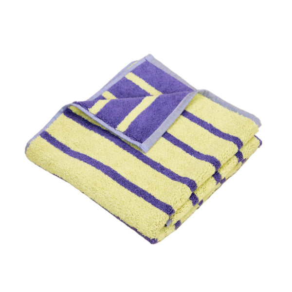 Set of yellow and purple cloths on a beige carpet