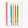 Notebook with colorful pencils on a white background