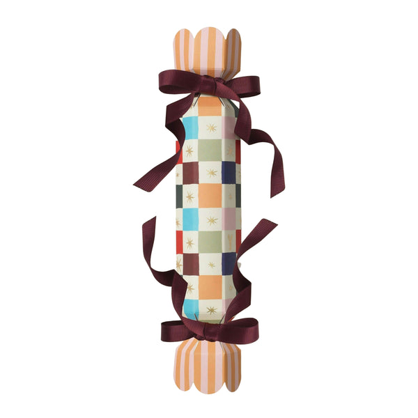 Decorative holiday cracker with plaid design and striped ends on a beige background