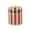 Colorful striped cylindrical container with a yellow knob on a beige background