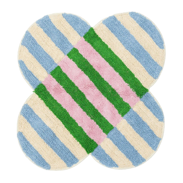 Clover-shaped bath mat with pastel color pattern on a grid background