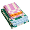 Stack of colorful checkered towels on a chair